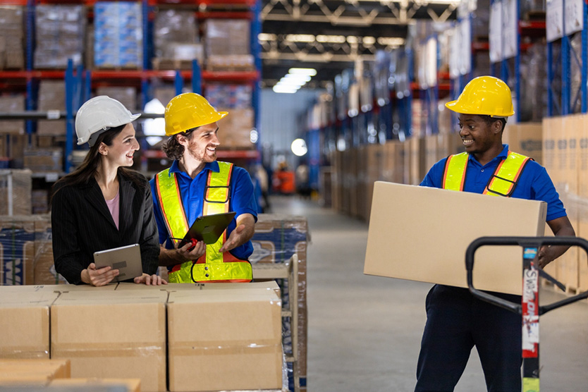 A warehouse worker assessing a load before lifting during a manual handling risk assessment